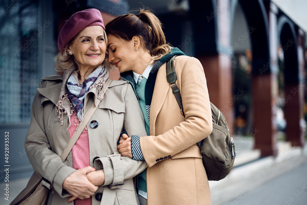 Mid adult woman feels grateful to have mother by her side in her life. Mid adult woman feels grateful to have mother by her side in her life.