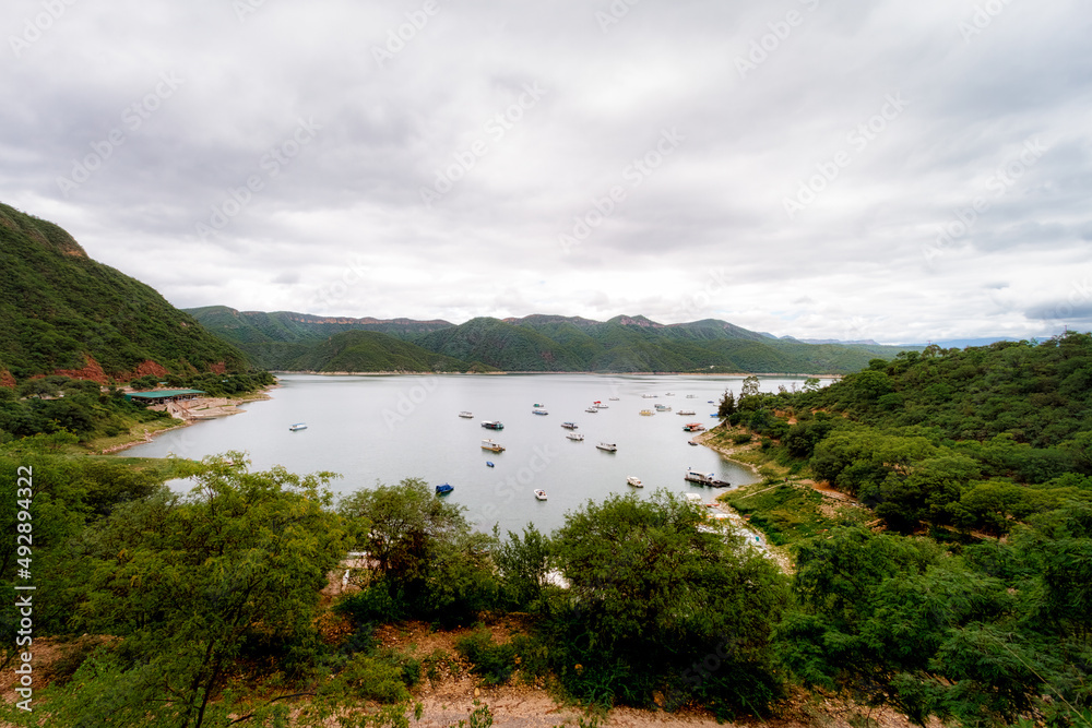 Panoramic view of the Cabra Corral reservoir with boats in Salta, Argentina