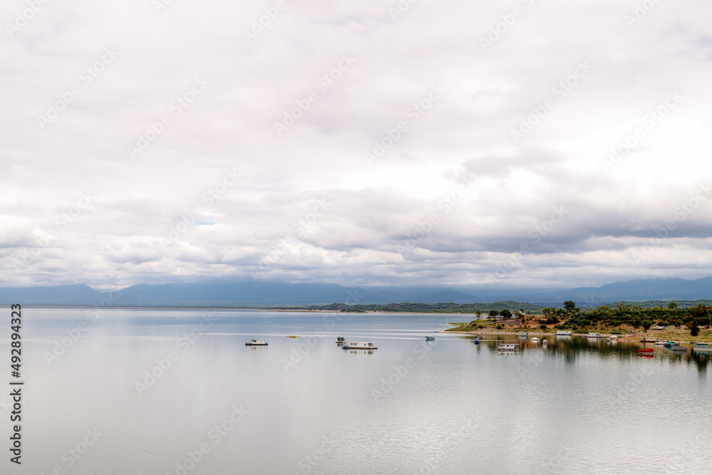 Panoramic view of the Cabra Corral reservoir with boats in Salta, Argentina