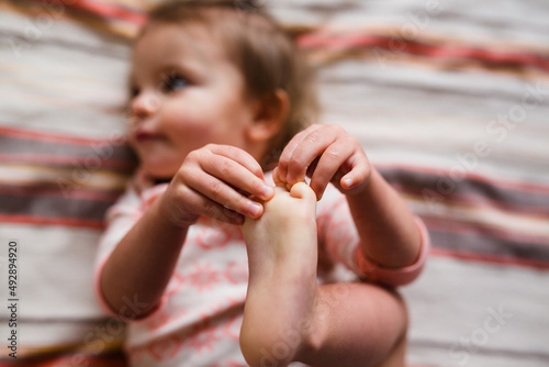 toddler grabs toes