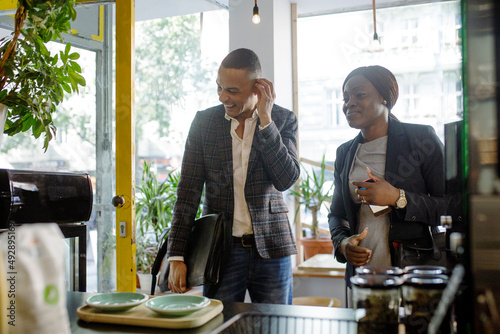 Two Business Colleagues Stopping In Coffee Shop On Way To Work