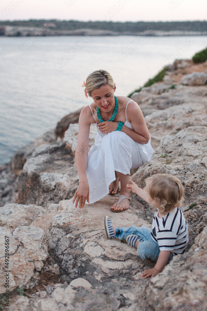 Happy mother enjoying a day with her son at the seaside Happy mother enjoying a day with her son at the seaside