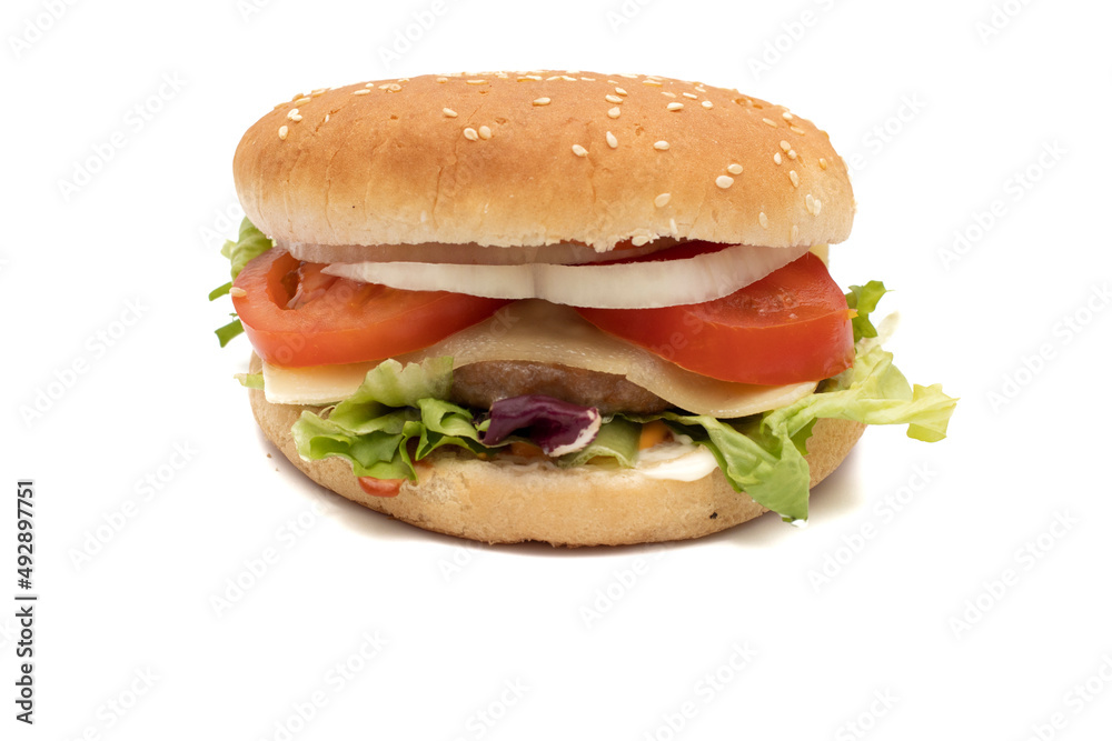 A hamburger, with the ingredients, lettuce, cabbage, cucumber, tomato, onion, cheese, ketchup, mayonnaise. Isolated on white background. One of the most consumed snacks in the world. A hamburger, with the ingredients, lettuce, cabbage, cucumber, tomato, onion, cheese, ketchup, mayonnaise. Isolated on white background. One of the most consumed snacks in the world.