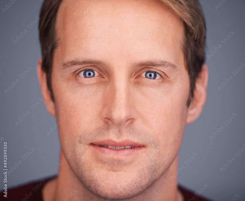 Keep it real. Closeup studio portrait of a handsome man with blue eyes.