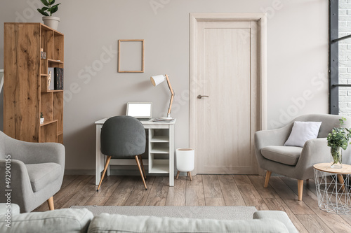 Schilderij op canvas Interior of light living room with wooden bookcase and modern workplace