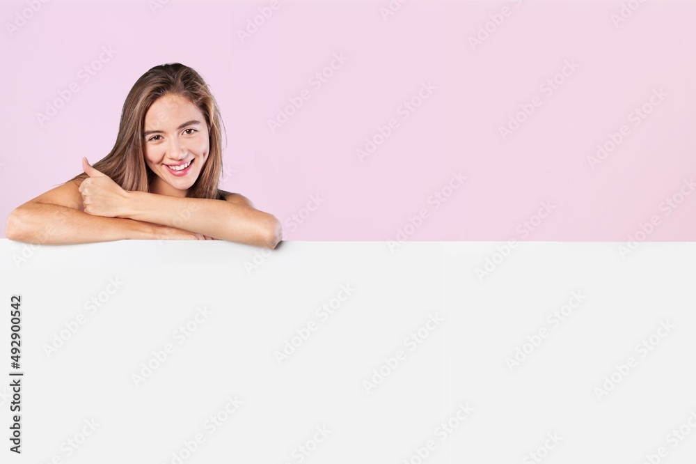 Check This. Smiling Lady Pointing Aside At Copy Space On Blank White Advertisement Board Check This. Smiling Lady Pointing Aside At Copy Space On Blank White Advertisement Board