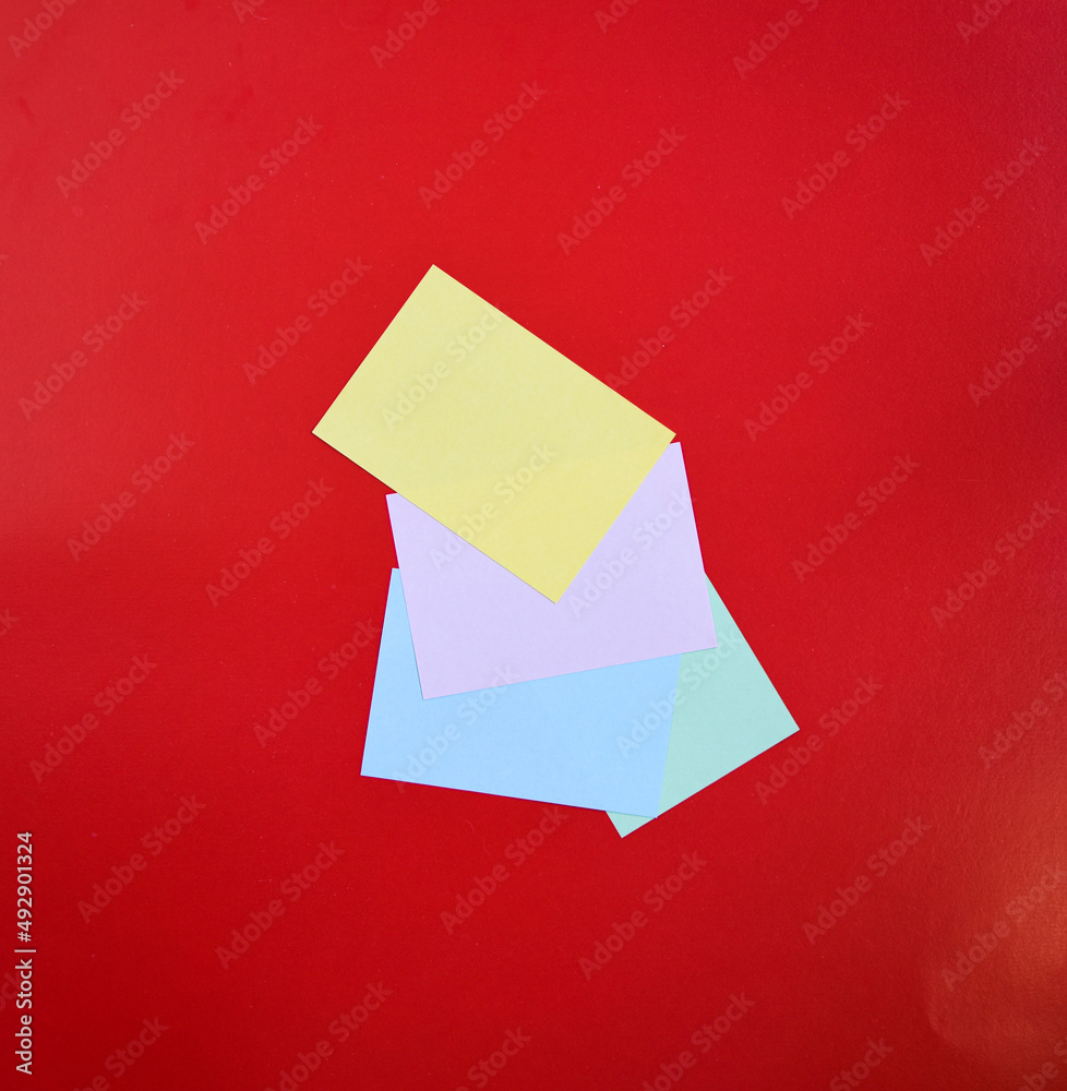 Colorful note papers over a red background. Reminder paper Colorful note papers over a red background. Reminder paper