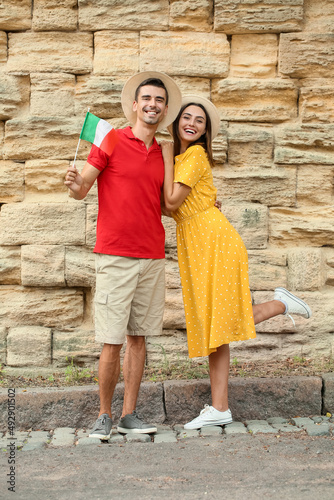 Young couple with Italian flag outdoors