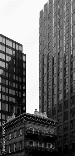 Black and White shot of Modern Skyscrapers in contrast with an old English pub in Victoria, central London, UK