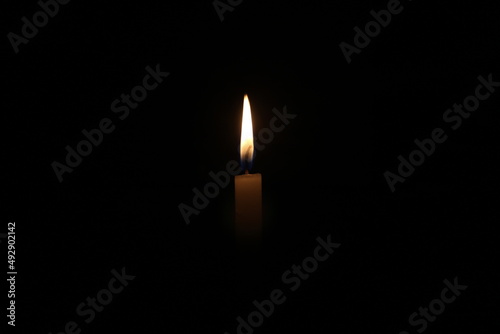 a candle is burning brightly in the dark