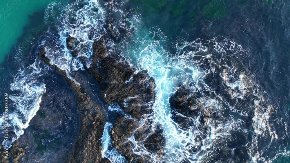 Waves and rocks. Sea waves texture. Nature background view from drone. Blue ocean water with rocks among foam on Laguna beach, California. Waves and rocks. Sea waves texture. Nature background view from drone. Blue ocean water with rocks among foam on Laguna beach, California.