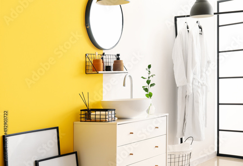 Interior of stylish bathroom with drawers, sink and mirror © Pixel-Shot