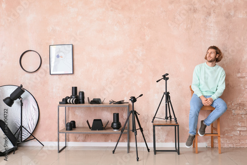 Young man sitting in chair ...