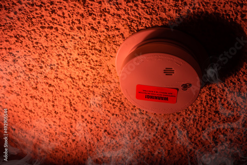 Security, burning house. Fire threat. Smoke detector and interconnected fire alarm.Smoke.with space for text photo