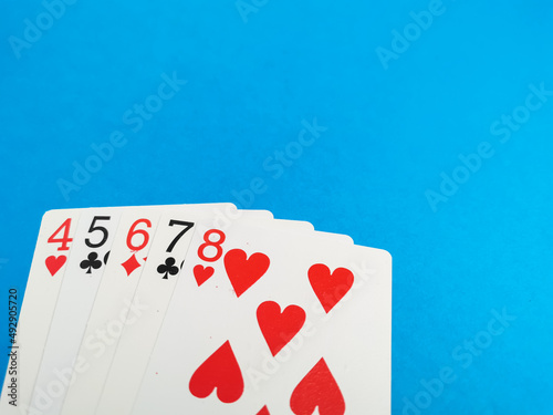 Photo of card games against blue background. Poker games and gambling concept.