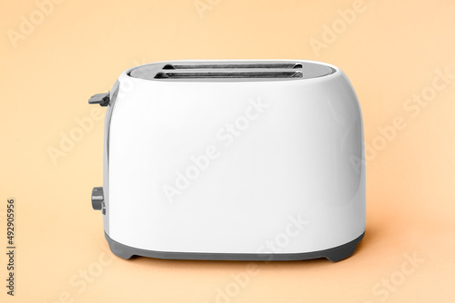 New modern toaster on beige background
