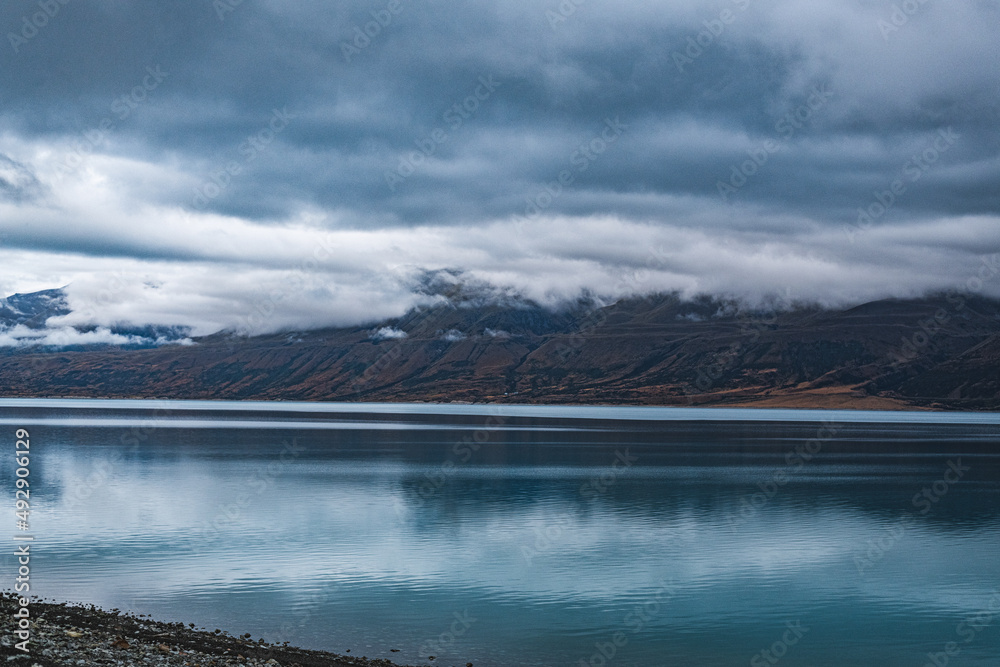 Grey clouds at mountain lake in New Zealand