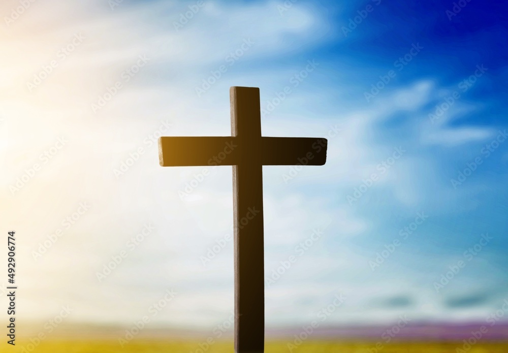 The wooden Cross at the sunset sky background