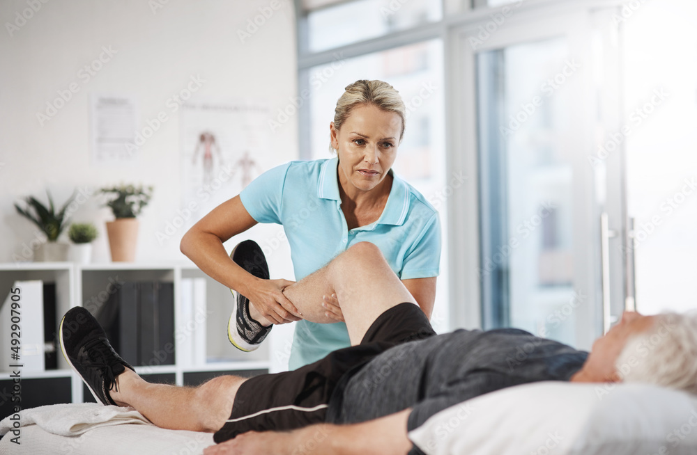 Obraz premium Lets test out your mobility. Cropped shot of a mature female physiotherapist working with a senior male patient in her office.
