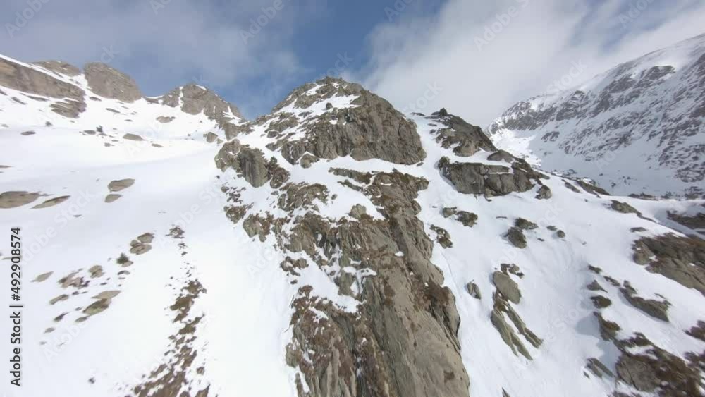 Controlled drone flight over peaks of Pyrenees mountains in winter season. Andorra. Aerial fpv