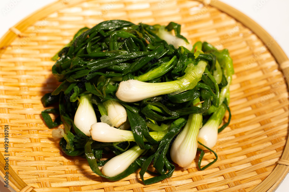 Pickled spring onion on bamboo plat Pickled spring onion on bamboo plat