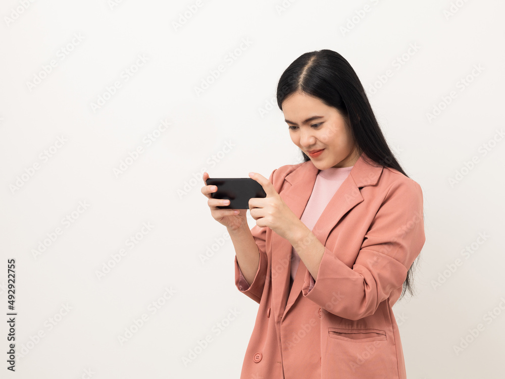 Cheerful young Asian woman using smartphone and checking message on mobile chat application isolated white background. Fashion style asian lovely woman playing game or shopping online by cellphone Cheerful young Asian woman using smartphone and checking message on mobile chat application isolated white background. Fashion style asian lovely woman playing game or shopping online by cellphone