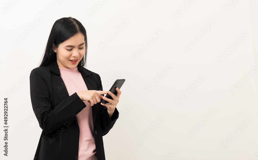 Cheerful young Asian woman using smartphone and checking message on mobile chat application isolated white background. Fashion style asian lovely woman playing game or shopping online by cellphone Cheerful young Asian woman using smartphone and checking message on mobile chat application isolated white background. Fashion style asian lovely woman playing game or shopping online by cellphone