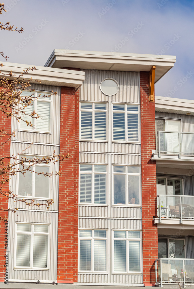 Brand new apartment building on sunny day in BC, Canada. Architectural details of modern apartment building