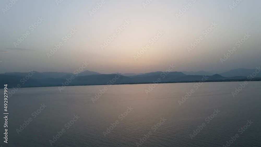 Horizon sunset with the silhouette of the mountains and calm ocean in the background. Panoramic view Horizon sunset with the silhouette of the mountains and calm ocean in the background. Panoramic view