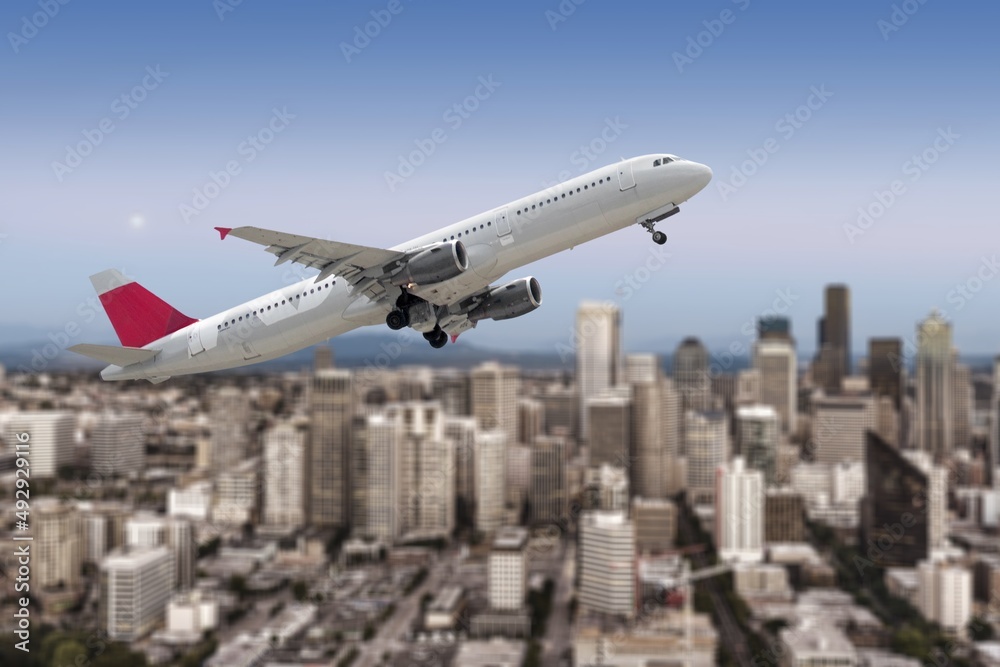 A big airplane jet taking off in cloudy sky on city background A big airplane jet taking off in cloudy sky on city background