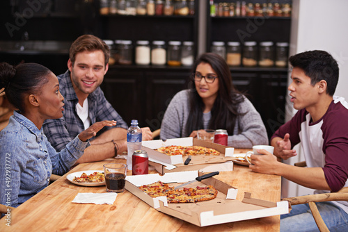 Enjoying pizza with great people. Cropped shot of a group of friends enjoying pizza together.