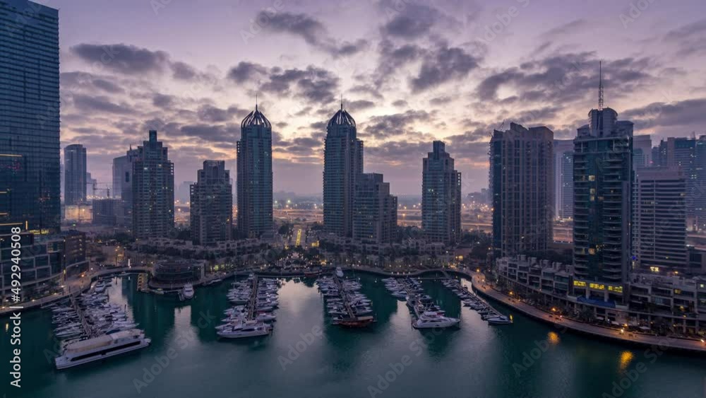 Aerial view of modern skyscrapers night to day timelapse before sunrise in Dubai Marina in Dubai, UAE. Aerial view of modern skyscrapers night to day timelapse before sunrise in Dubai Marina in Dubai, UAE.