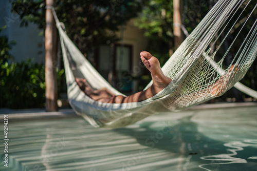 person relaxing in hammock
