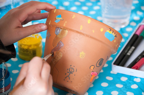 girl hands painting pots