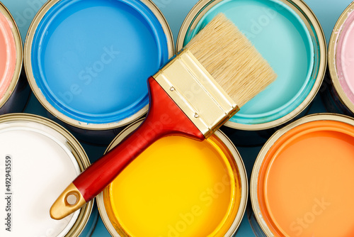 Paint cans and paint brushes and how to choose the perfect interior paint color and good for health photo