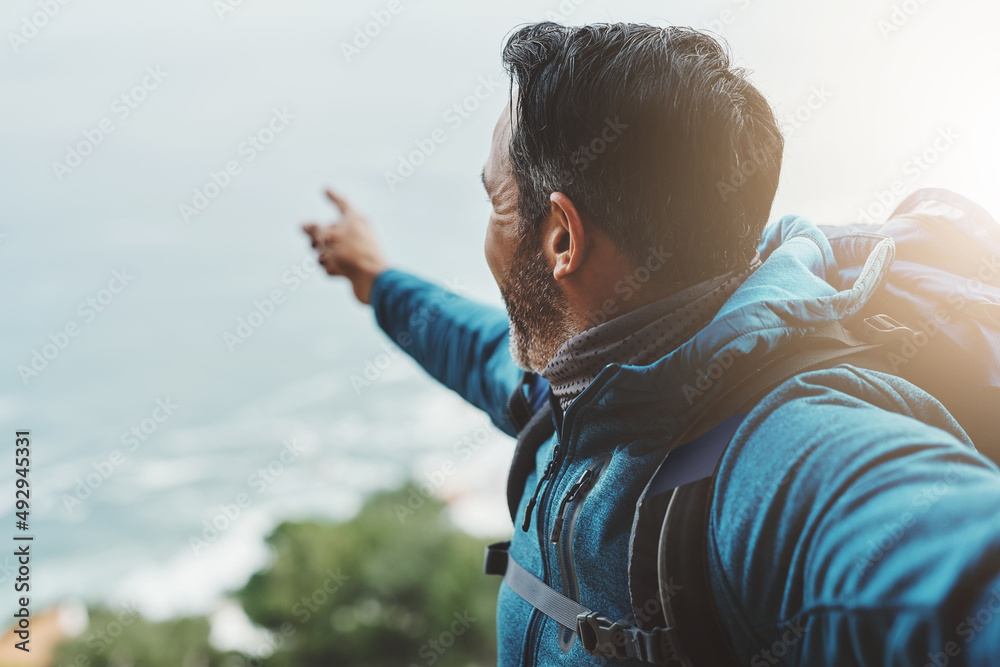 Theres always plenty more to show in nature. Shot of a middle aged man looking at the view on top of a mountain. Theres always plenty more to show in nature. Shot of a middle aged man looking at the view on top of a mountain.