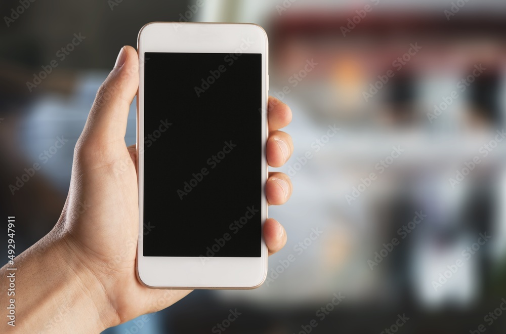 Business and financial concept. Hand with black screen smartphone for logo