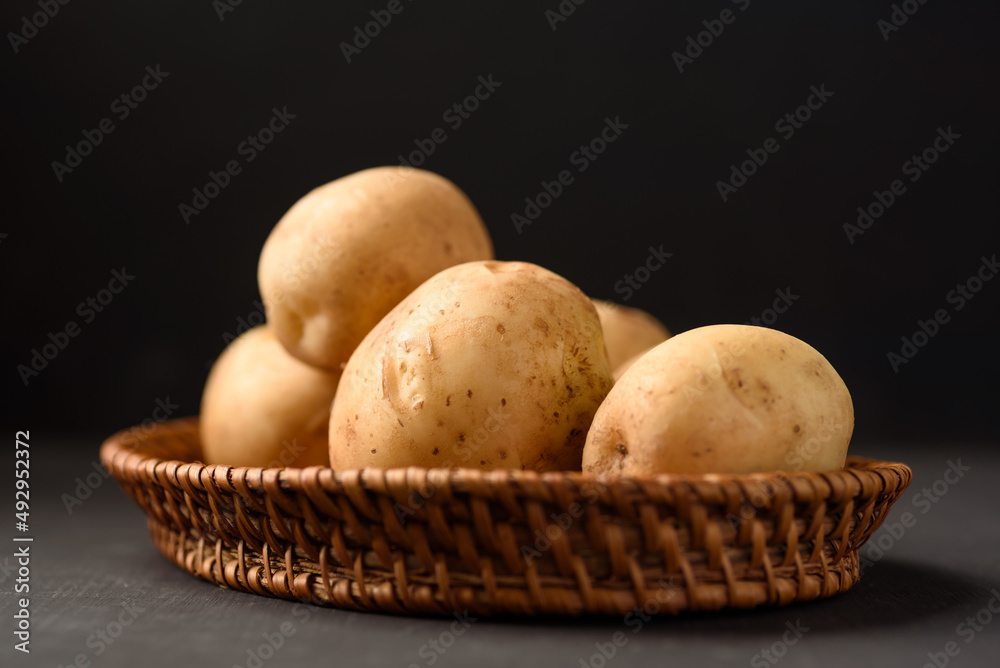 Organic potato from Thai farmer local market on black background Organic potato from Thai farmer local market on black background