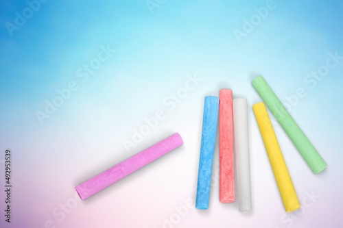 Stack of colored chalk on background