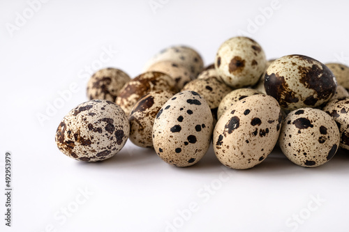 quail eggs on white background for sale to customer. Business of quail breeding, poultry farming. Healthy food, buying eggs for Easter holiday