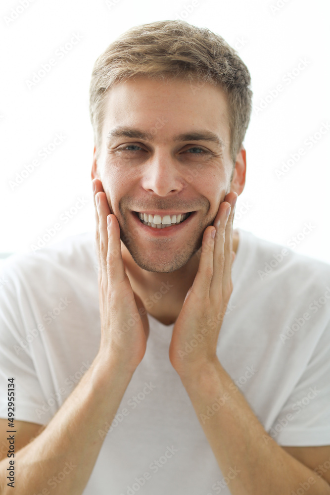 Young man checking his stubble in bathroom Young man checking his stubble in bathroom