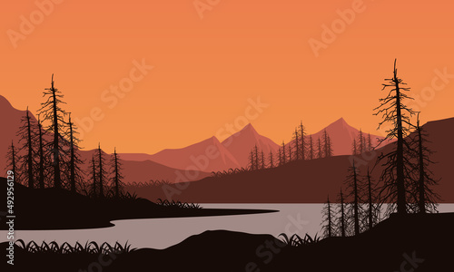 Mountain view with a realistic silhouette of dry pine trees from lakeside