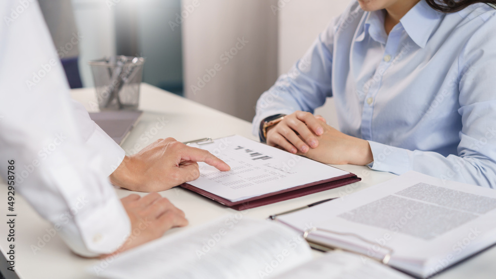 Business concept, Business colleague pointing on document to explain financial data to partner Business concept, Business colleague pointing on document to explain financial data to partner