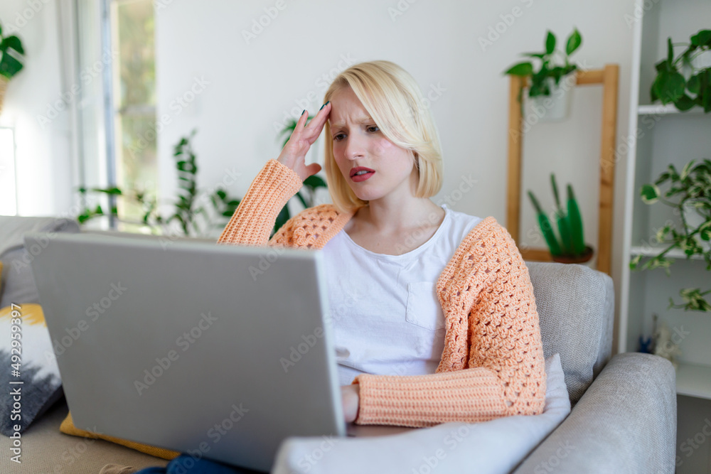 Young woman sit at home office reading email or contract feel confused with bad news, frustrated woman stunned by received paperwork correspondence Young woman sit at home office reading email or contract feel confused with bad news, frustrated woman stunned by received paperwork correspondence