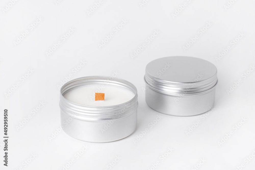 Soy candles in metal cans, handmade modern hobby , harmless coconut wax candles without paraffin on white background isolated Soy candles in metal cans, handmade modern hobby , harmless coconut wax candles without paraffin on white background isolated