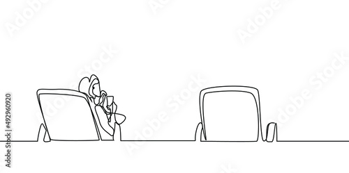 a woman sitting alone on one of the beach sunbeds and an empty sunbed next to her