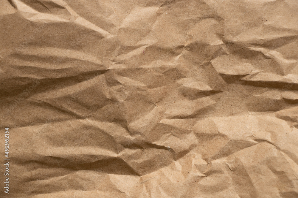 Obraz premium Brown crumpled paper as background close-up,brown background