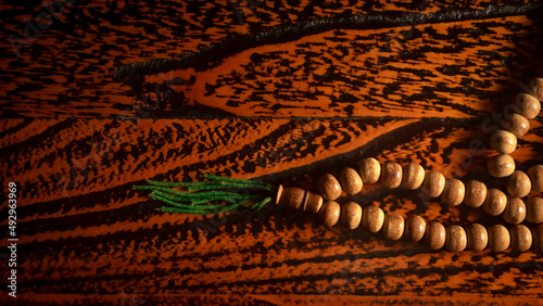 close up of wood tasbih with blur bokeh on wooden background. Wooden rosary photo