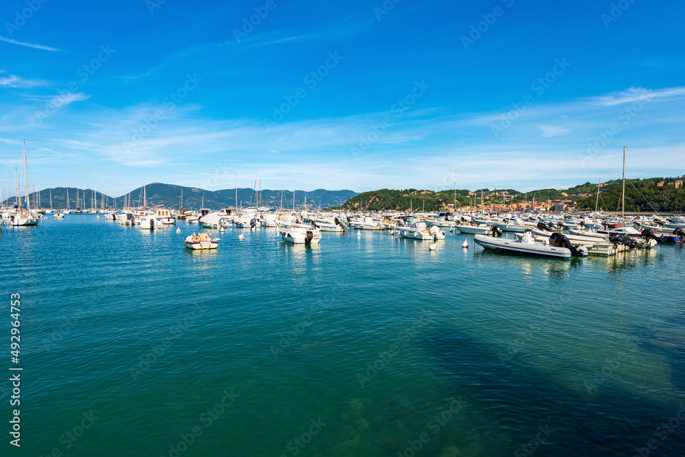 Port of Lerici town with many recreational boats moored and the village of San Terenzo. Tourist resorts on the coast of Gulf of La Spezia, Liguria, Mediterranean sea, Italy, Southern Europe.