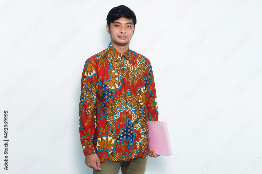 asian young man wearing batik confident while holding a pink envelope isolated on white background
asian young man wearing batik confident while holding a pink envelope isolated on white background